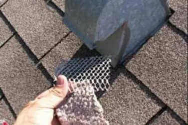 Lint-clogged screen pulled from a roof exhaust vent