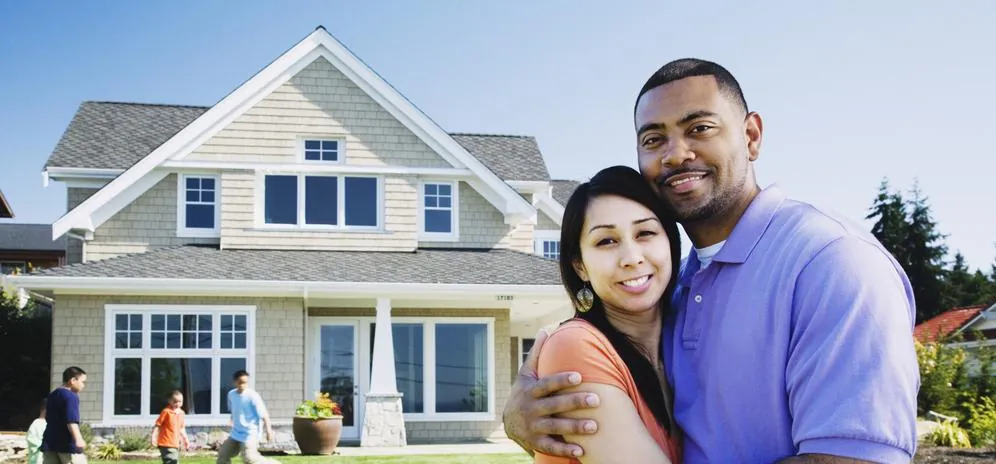 Family in front of their home after air duct cleaning by Healthy Air Resolutions